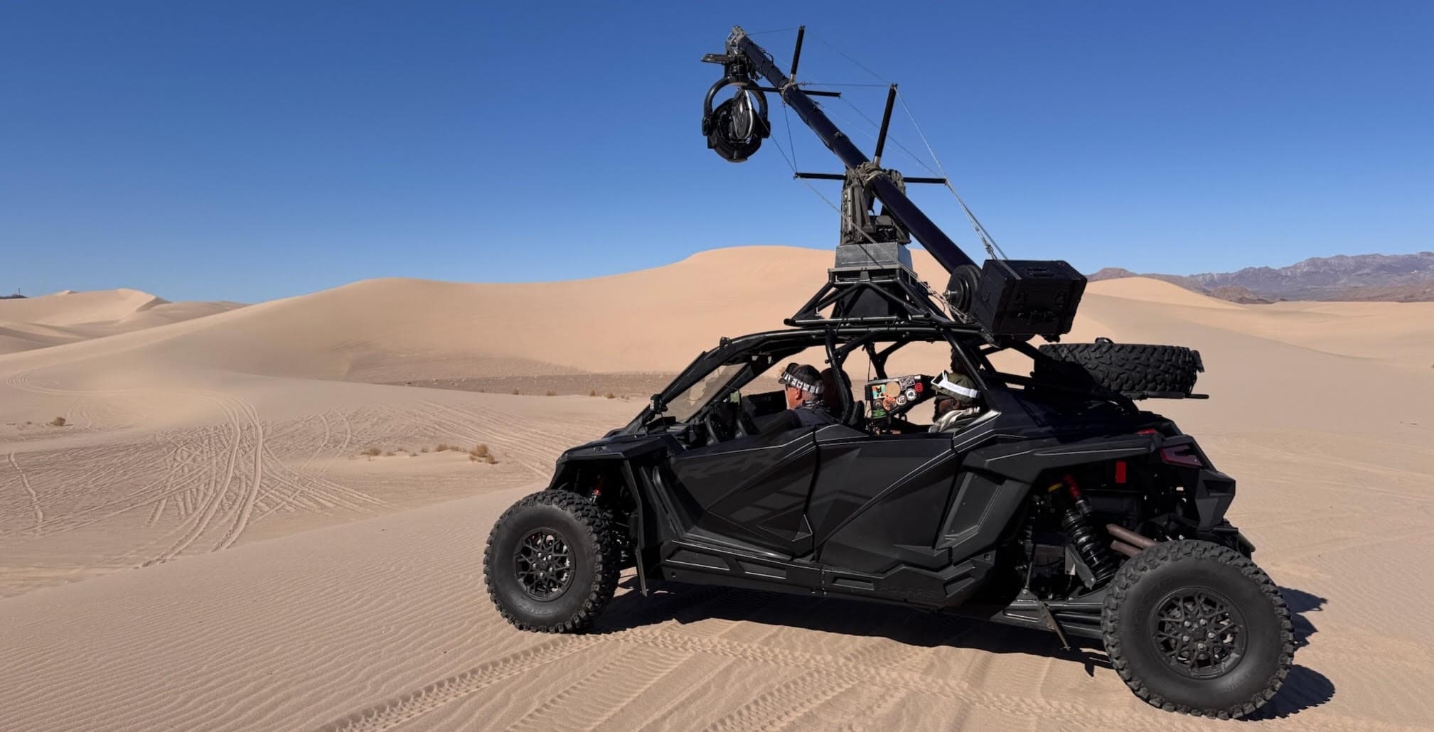 Polaris RZR with camera crane in sand dunes