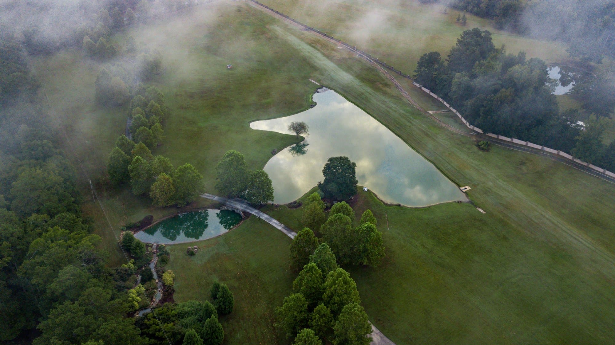 Aerial view of ponds and bridge